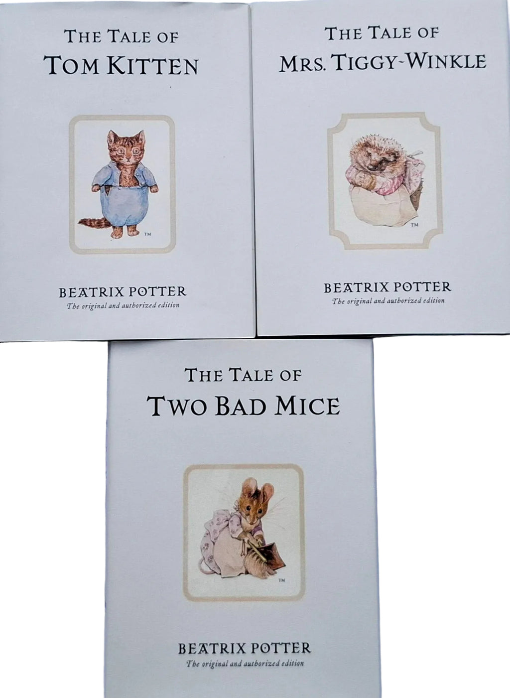 Three books from Beatrix Potter's series on a light blue background