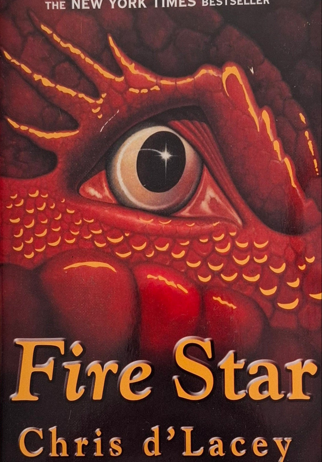 Book cover of 'Fire Star' by Chris d'Lacey with a red eye design on a white background